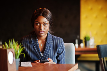 African american businesswoman sitting at table in cafe. Black girl having rest.