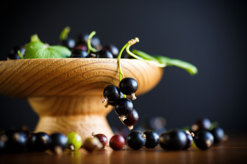 ripe berries black currants on a wooden table
