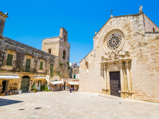 Otranto, Apulia, Italy - Jul 09, 2018: The medieval Cathedral in the historic center of Otranto, coastal town of Greek-Messapian origins in Italy, a fertile region once famous for its breed of horses - obrazy, fototapety, plakaty