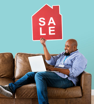 Man holding a house sale icon