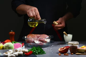 Foto op Canvas Chef pouring oil on rabbit meat, cooking process, restaurant concept © Надія Коваль