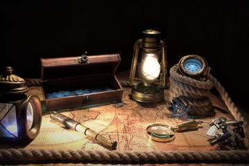 Obraz na płótnie Canvas Old ship lantern,compass,coins,monocle,loupe, sextants,rope and pirate map. Travel and marine engraving background. Treasure hood concept. Vintage style.