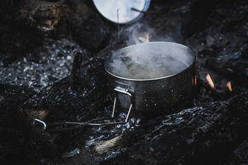 Cauldron in the mountains. Food is cooked on fire. Dishes for hiking. Traveling.