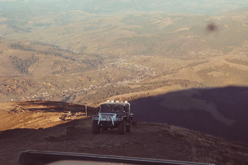 Offroad car in Carpathians. Mountains Mount Gimbia Traveling by car. Landscapes of autumn mountains.