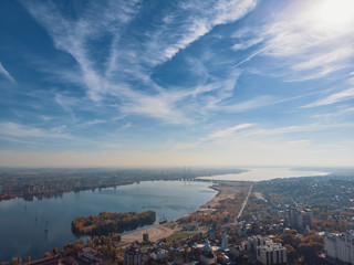 Aerial panoramic view of modern city from above with river in sunny day, copy space