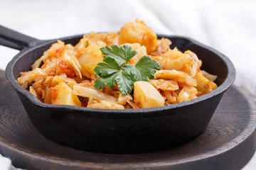 Cabbage stewed with potatoes. Vegetable ragout. Vegan and vegetarian cuisine.
