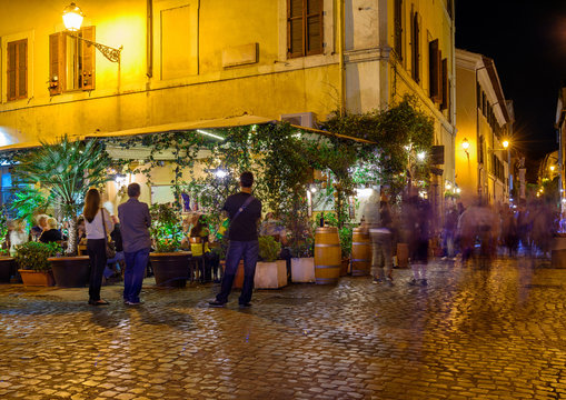 Night view of old street in Trastevere in Rome, Italy. Trastevere is rione of Rome, on the west bank of the Tiber in Rome, Lazio, Italy.  Architecture and landmark of Rome