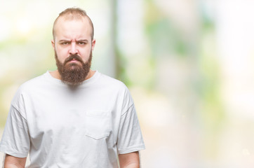 Young caucasian hipster man wearing casual t-shirt over isolated background skeptic and nervous, frowning upset because of problem. Negative person.