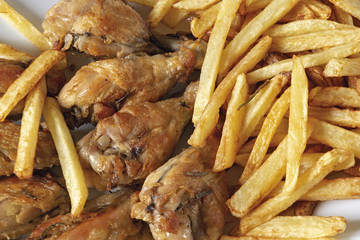 piatto ovale ali di pollo arrosto con patatine fritte dall'alto primo piano