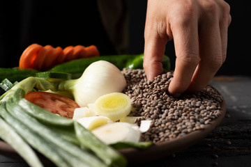 man preparing a vegetarian lentil stew