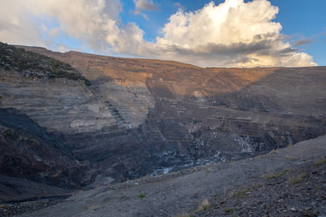 Beautiful sunset with some cumulus clouds in a coal open pit mine