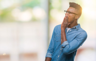 Young african american man over isolated background shouting and screaming loud to side with hand on mouth. Communication concept.