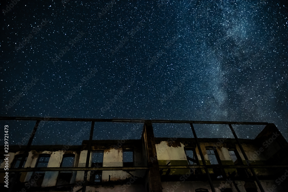 Wall mural night sky and the milky way over the old abandoned house