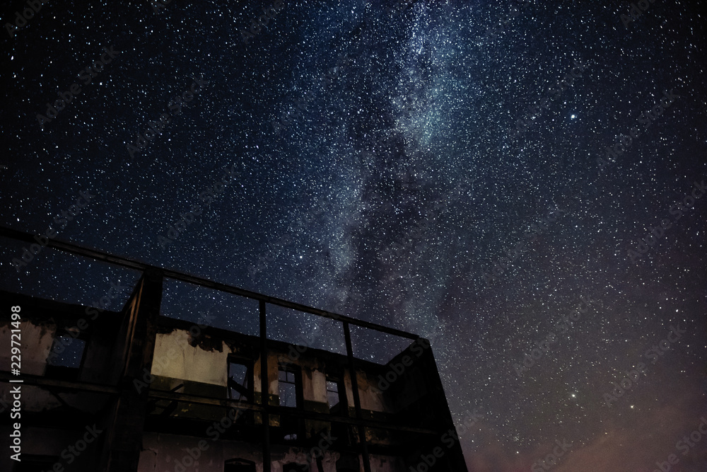 Wall mural night sky and the milky way over the old abandoned house