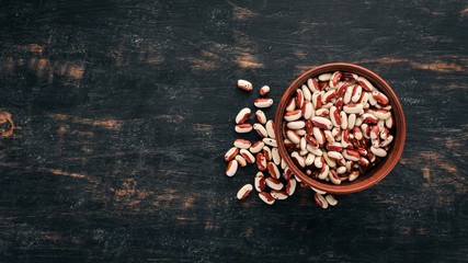 Bean On a black wooden background. Top view. Free copy space.