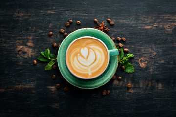 Cappuccino. Coffee with milk. On a black wooden background. Top view. Free copy space.