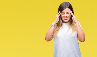 Young beautiful woman casual white t-shirt over isolated background with hand on head for pain in head because stress. Suffering migraine.