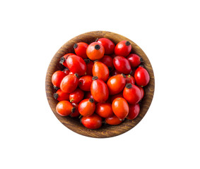 Fresh rosehip berries on white background. Top view. Rosehip berries in a bowl isolated on white background. Rose hip berries with copy space for text.