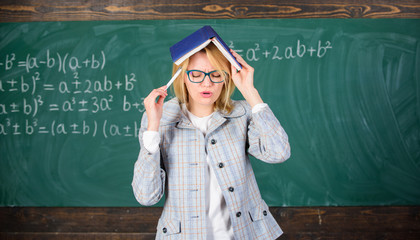 Woman teacher with book as roof on head. Memorizing method. Train memory every day. Effective method to remember information. Cognitive process concept. Keep in memory. Improve memory skill