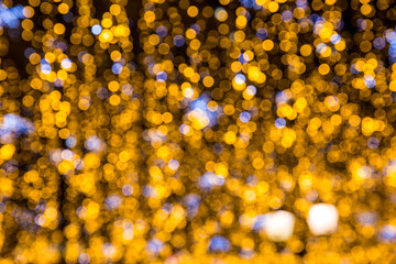 Yellow christmas background with colorful bokeh light effects