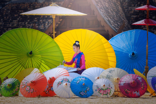Portrait of a woman painting traditional parasols, Chiang Mai, Thailand