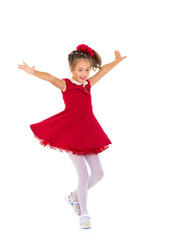 A little girl in a dress is spinning. © lotosfoto