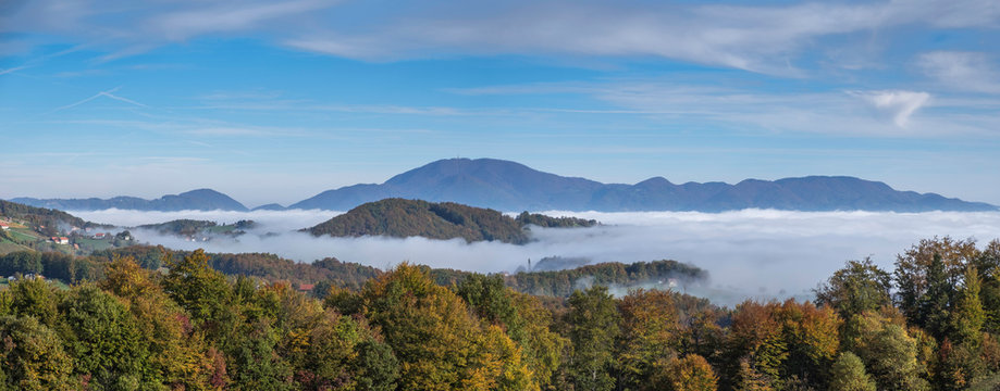 Mountain Boc rising over foggy landscape in Styria, Slovenia