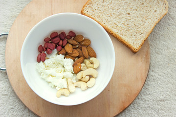 Healthy meals with nuts,  bread and Ñottage cheese,.