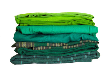 Stack green winter clothes isolated on white background