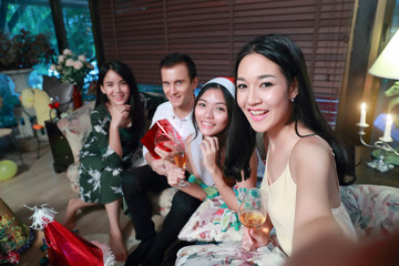 Happy group of friends celebrating new year party and do self portrait