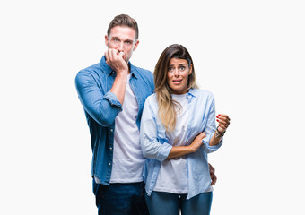 Young couple in love over isolated background looking stressed and nervous with hands on mouth biting nails. Anxiety problem.
