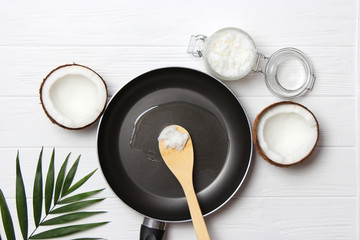 Frying pan and coconut oil on a wooden table. Top view. fry in coconut oil.