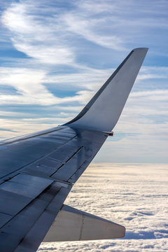 Wng of an airplane and cloudy sky during a flight