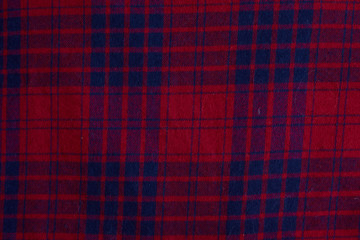 Texture of warm knitted plaid clothing.