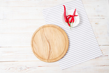 wooden desk, striped napkin,red pepper on table.Tablecloth holiday concept