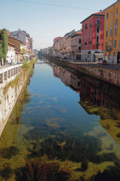 Transparent water in channel Naviglio Grande. Milan, Italy