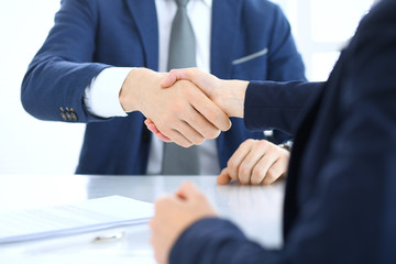 Group of business people or lawyers shaking hands finishing up a meeting , close-up. Success at negotiation and handshake concepts