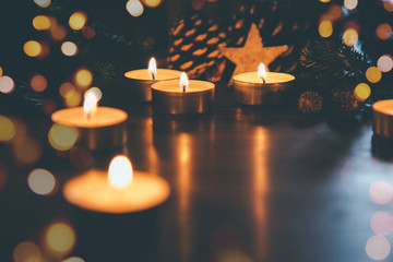 Christmas candles with ornaments and lights bokeh