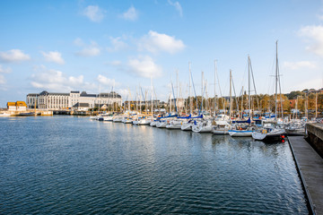Fototapeta na wymiar Landscape view on the harbour with beautiful yachts and buildings during the morning light in Deauvillle village in France