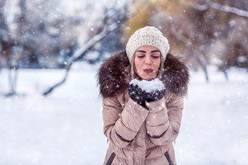 Christmas Winter Girl blowing Magic snow in Her Hand. Fairy. Beautiful New Year and Xmas Holiday .