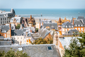 Top view of Trouville city with rooftops of luxury houses and ocean on the background in France © rh2010