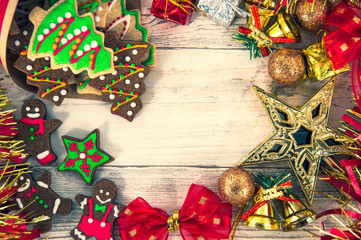 Beautiful Christmas composition and decoration with baked Christmas gingerbread cookies in paper bag on light wooden background, flat lay, top view, copy space (text space)