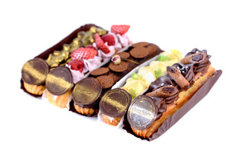 Delicious dessert on a white background. A fresh and tasty eclair is isolated on a white background, with beautiful decor.