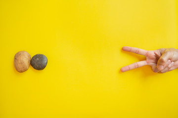 Rock Paper Scissors on yellow background, Top View, Copy-space.