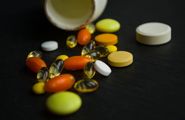 Pills spilling from a white bottle