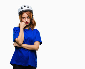 Young beautiful woman wearing cyclist helmet over isolated background thinking looking tired and bored with depression problems with crossed arms.