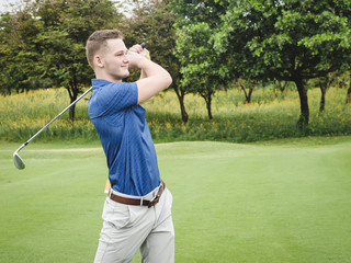 Happy golfer playing golf on green field, lifestyle concept.