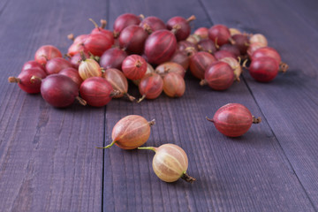 Obraz na płótnie Canvas Fresh gooseberry on rustic wooden table. Ripe berry background. Healthy food concept. Angle view