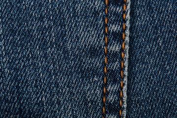Denim jeans texture background with seam closeup. Stitched texture of the cotton fabric