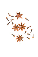 Anise star with cloves on white background top view